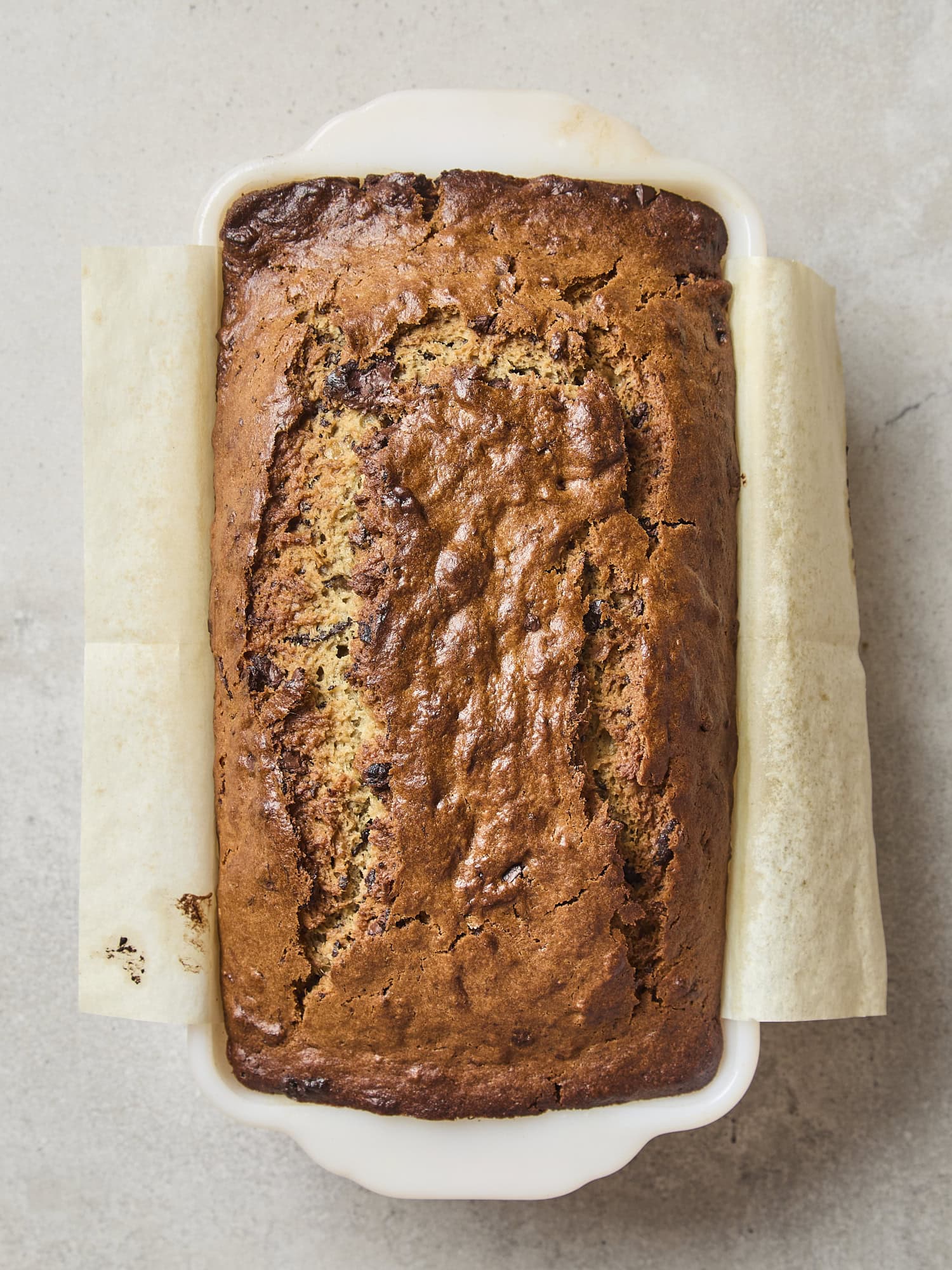 Golden brown baked banana bread with chocolate pieces.