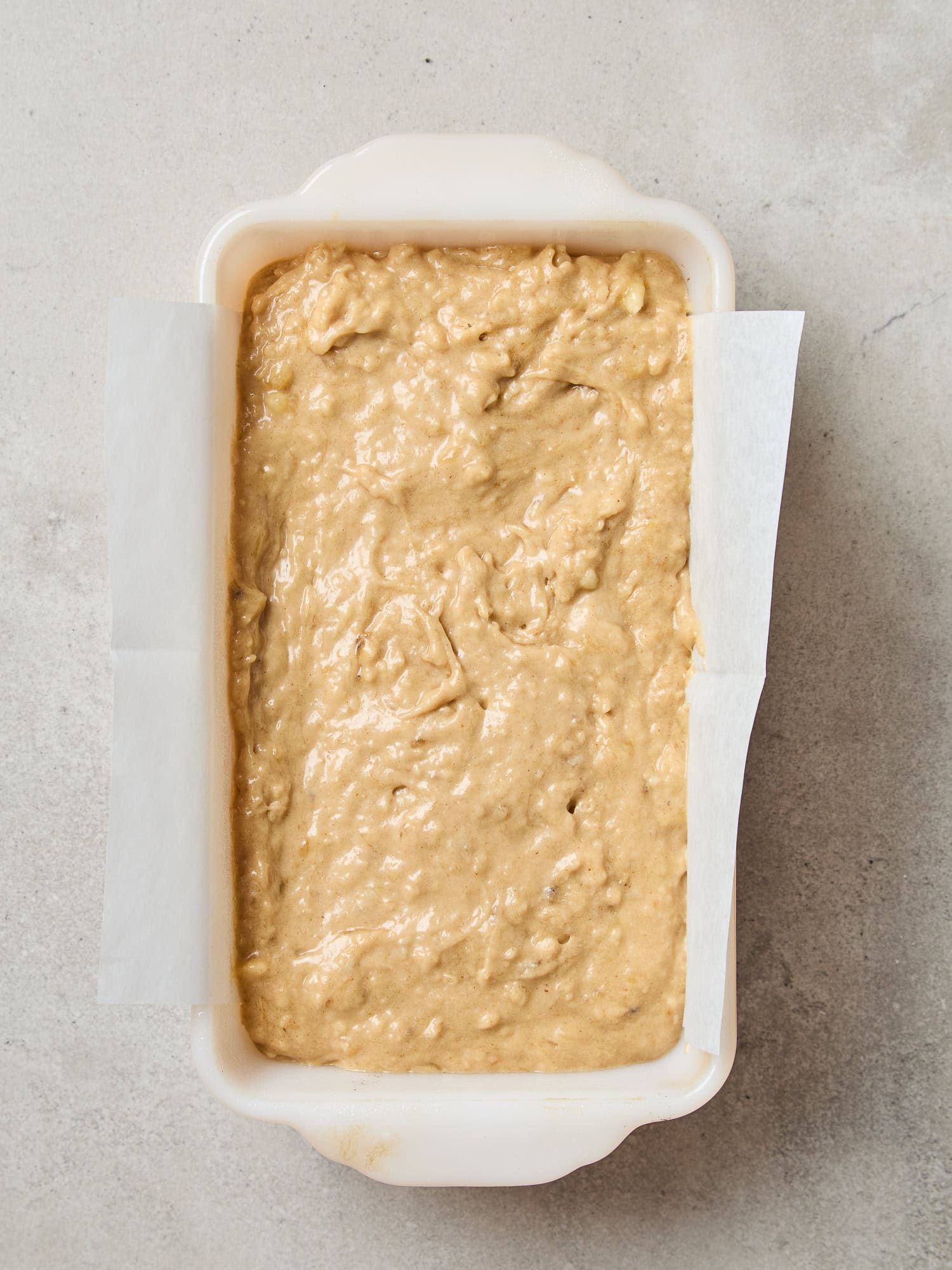 Classic banana bread batter in a loaf pan prior to baking.