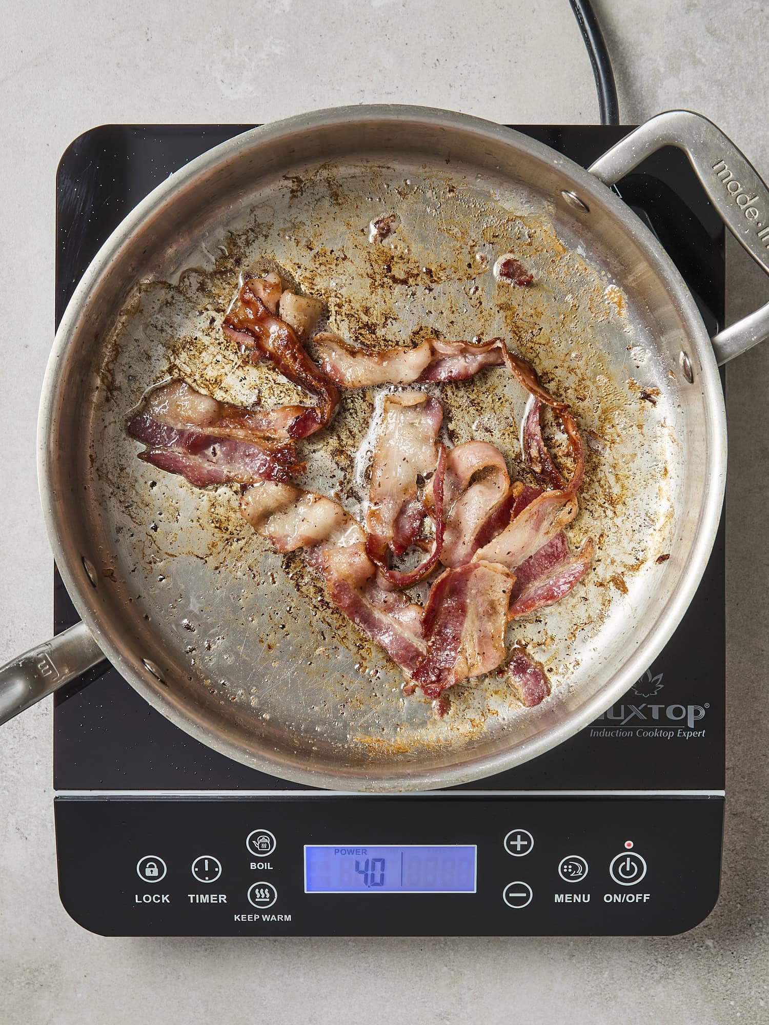 Cooking bacon in pan.