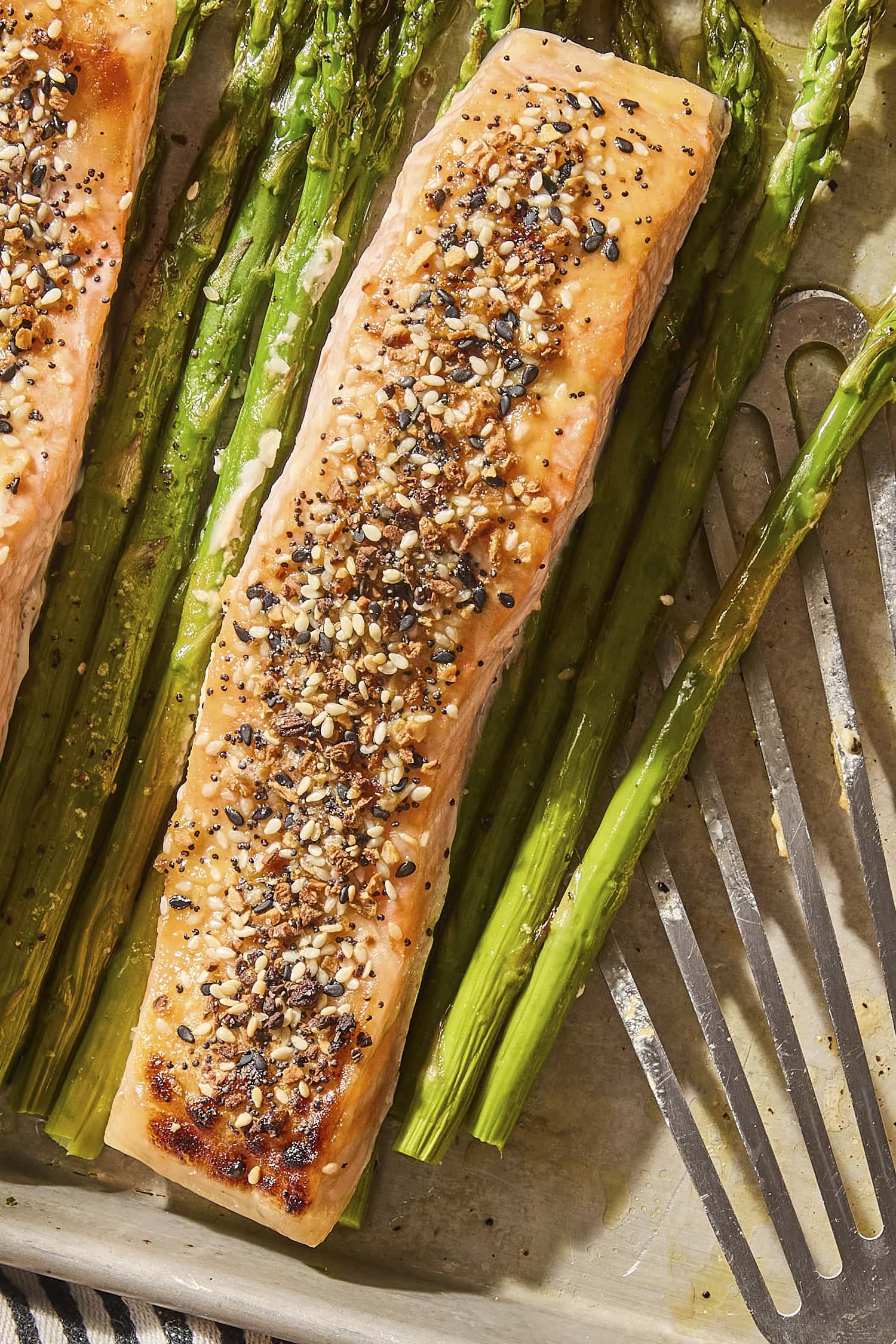 Salmon roasted on a sheet pan with salmon with everything bagel seasoning on top.