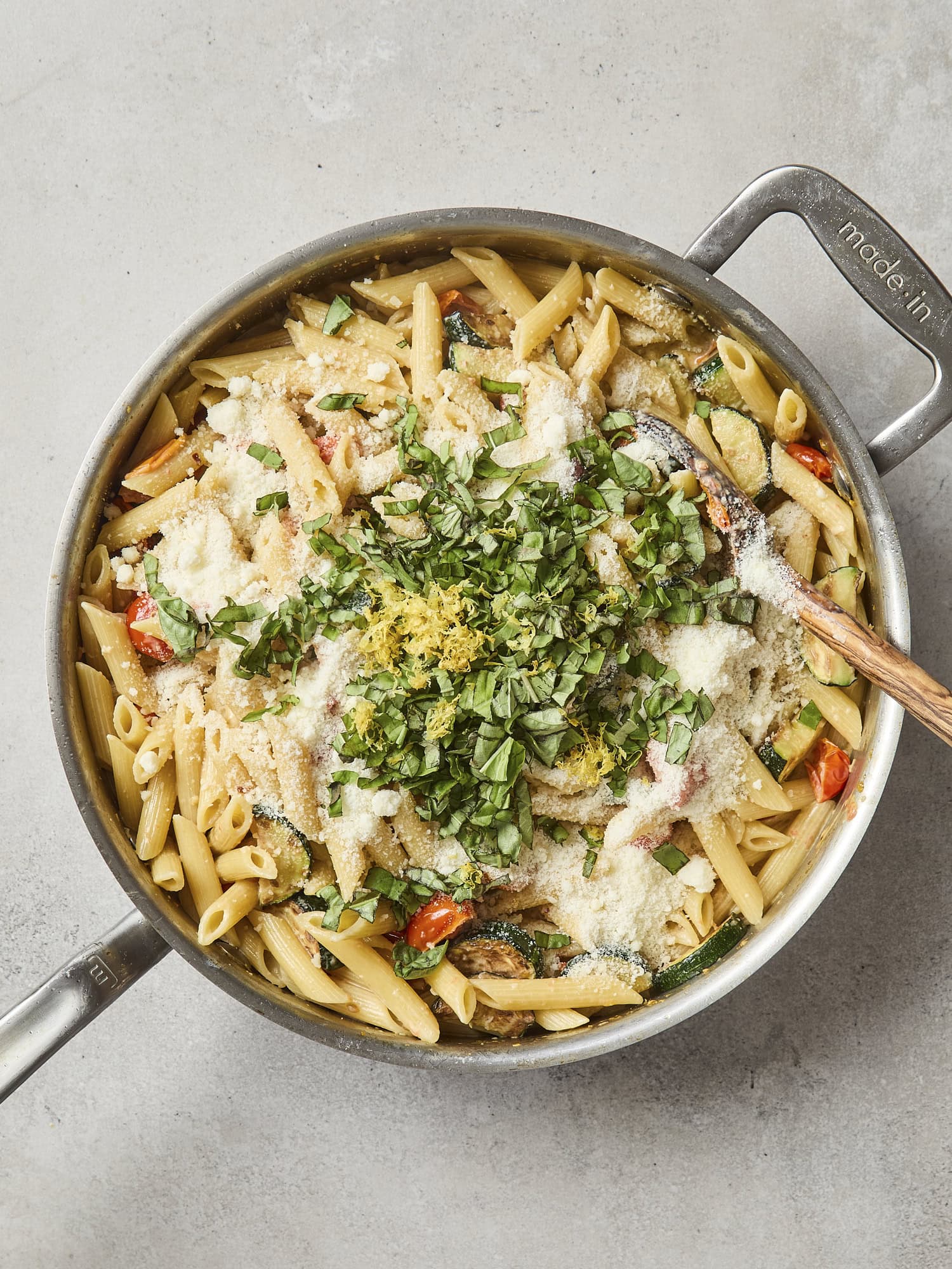 Basil and Parmesan cheese on top of creamy pasta.