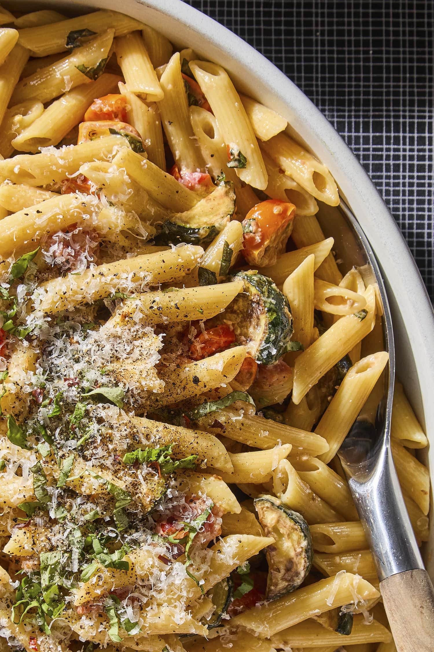 Penne with creamy sauce with zucchini and tomatoes.