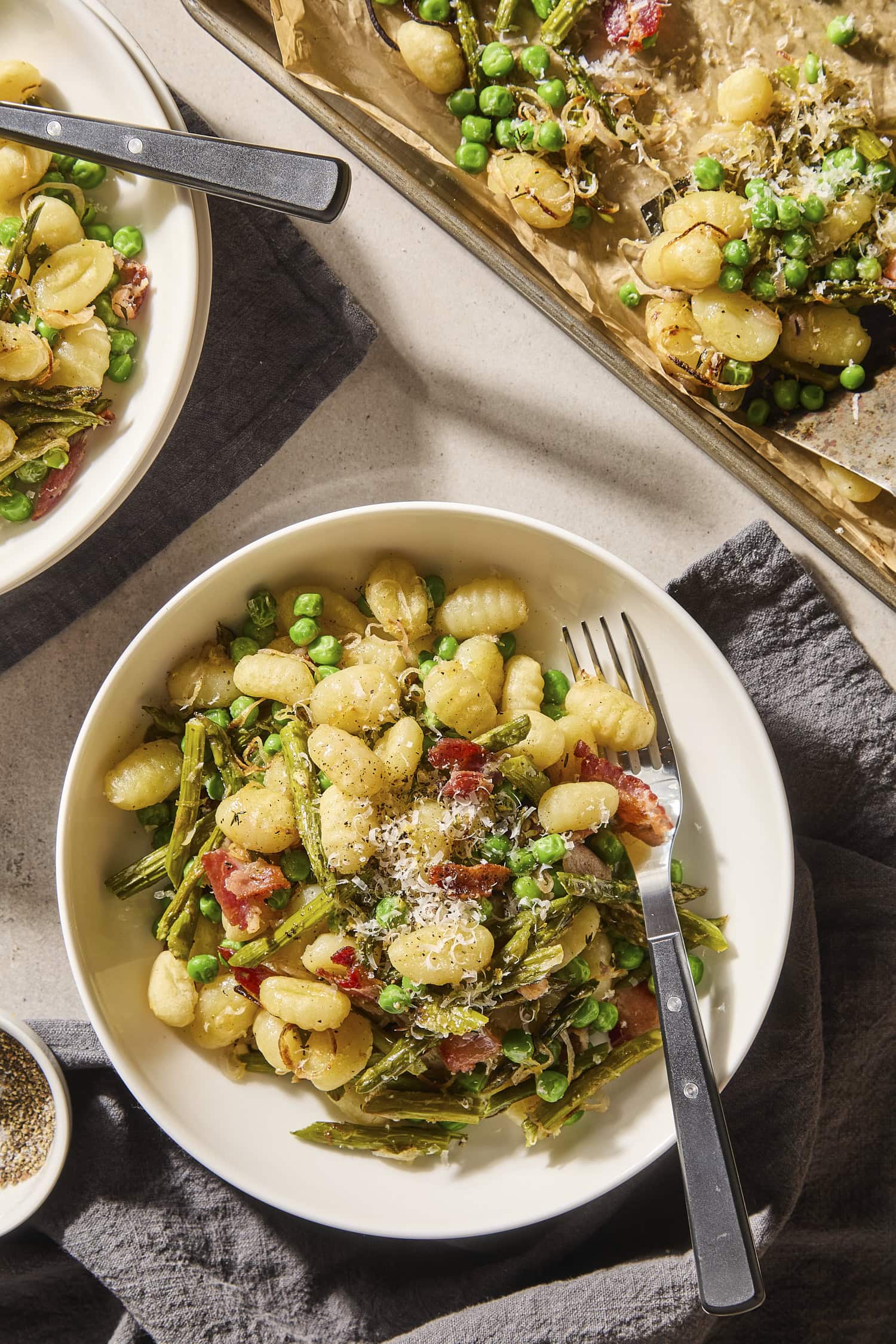 Bowl of sheet pan gnocchi with asparagus.