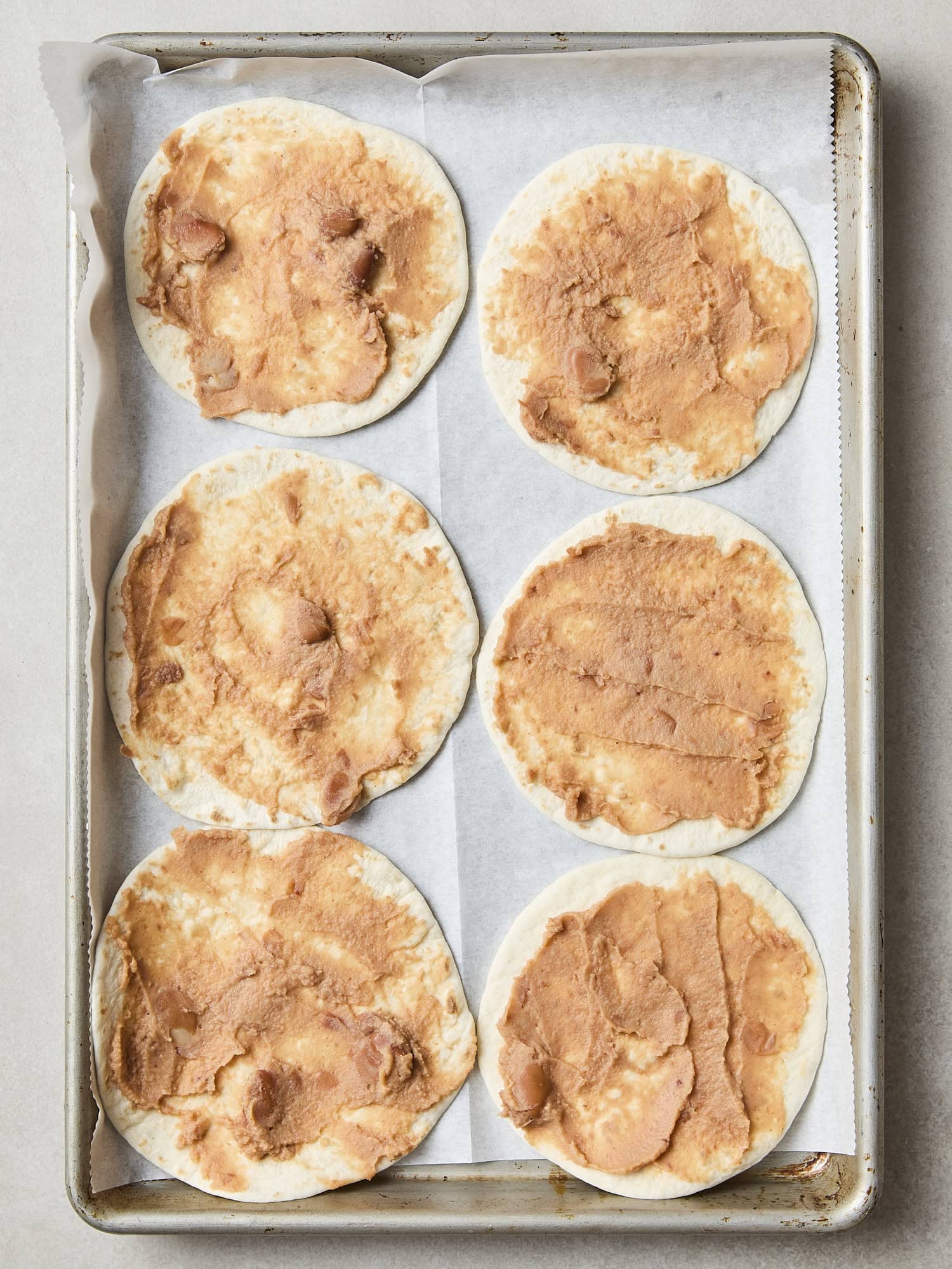 Tortilla spread with refried beans.