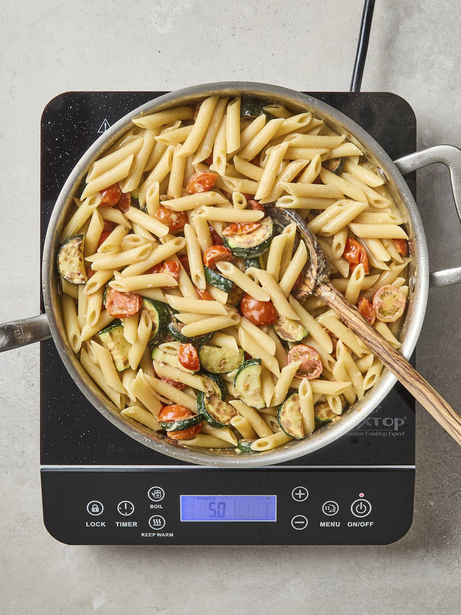 Creamy pasta mixed together over heat.