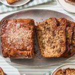 Sliced banana bread with chocolate chunks and tahini glaze.