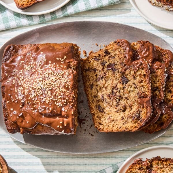Sliced banana bread with chocolate chunks and tahini glaze.