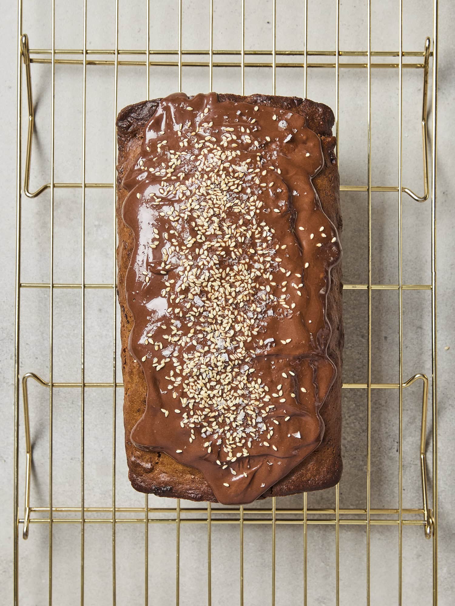 Banana bread topped with chocolate glaze and sesame seeds.