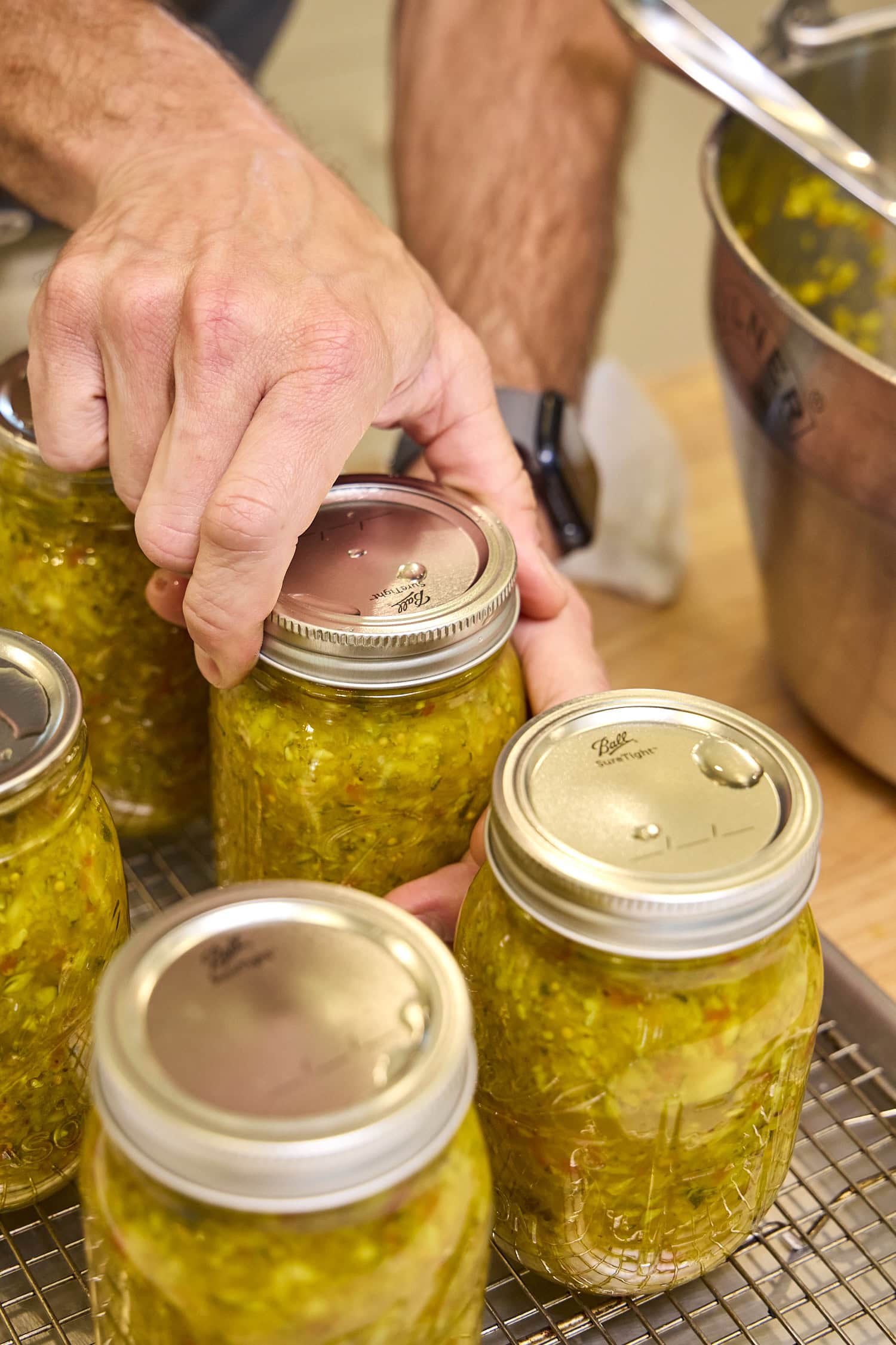 Tightening lid and rid on glass canning jar.