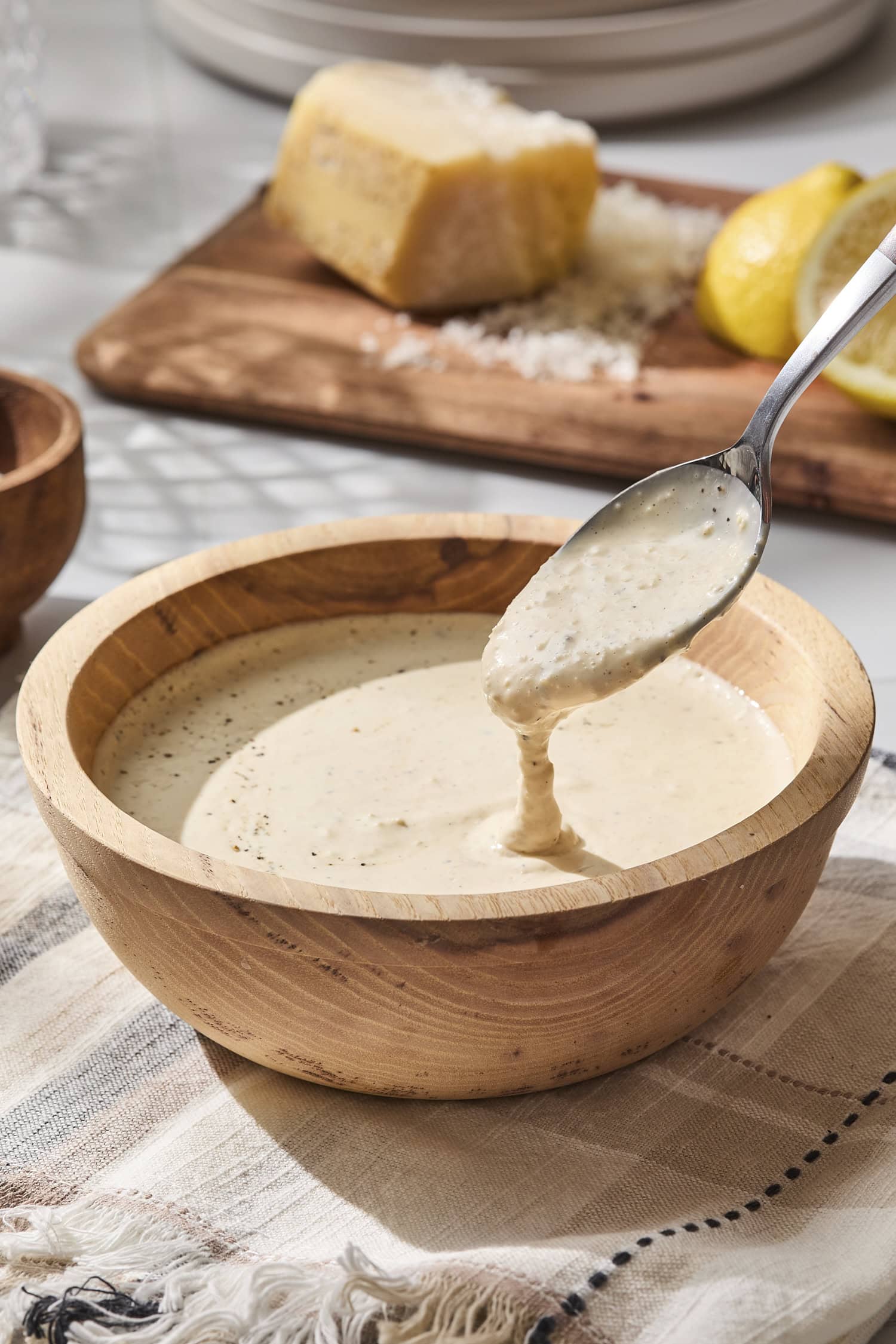 Small bowl with spoon showing Caesar dressing texture.