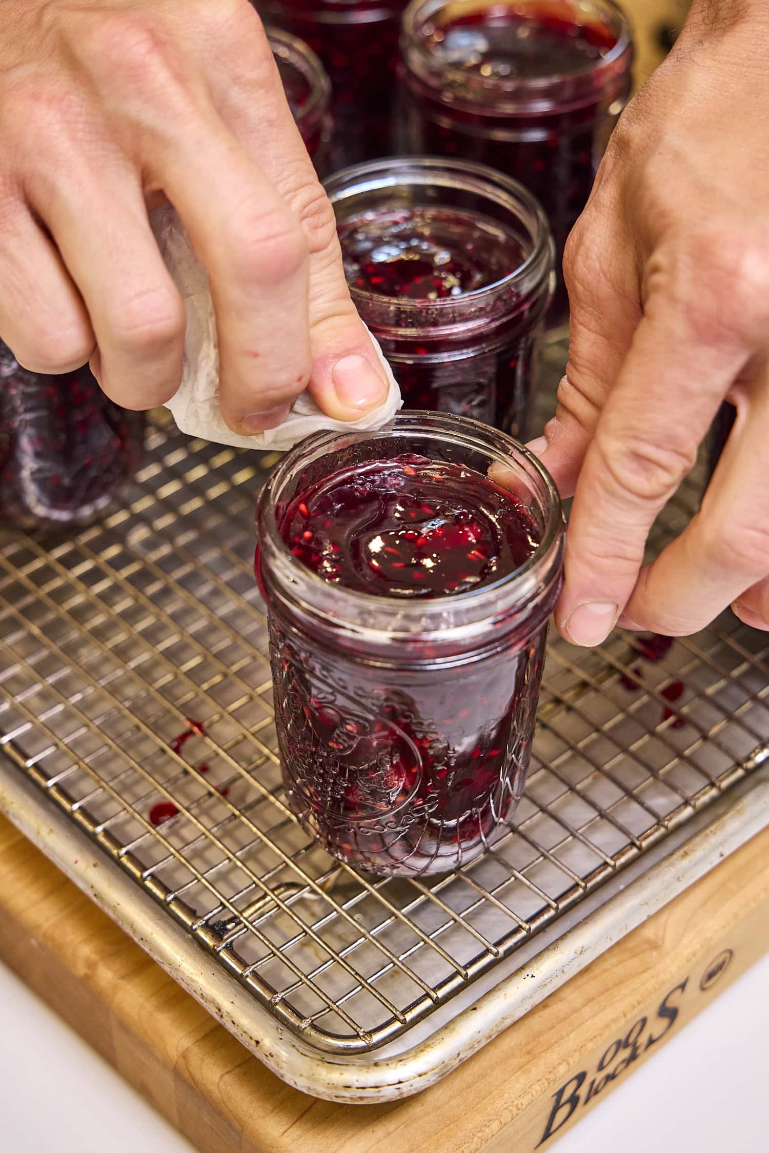 Wiping the rim off of canning jar.