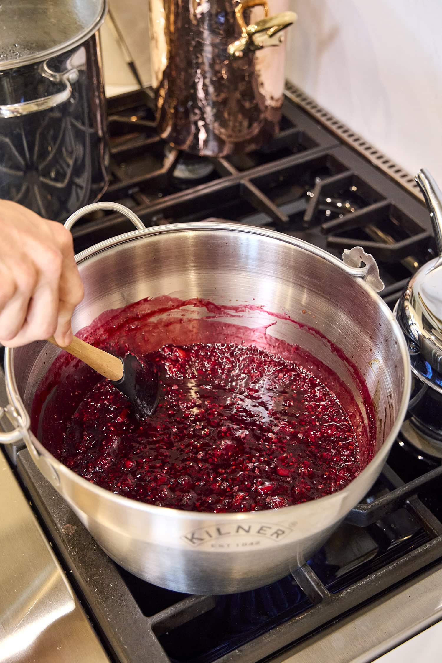 Cooked blackberry jam in big pot.