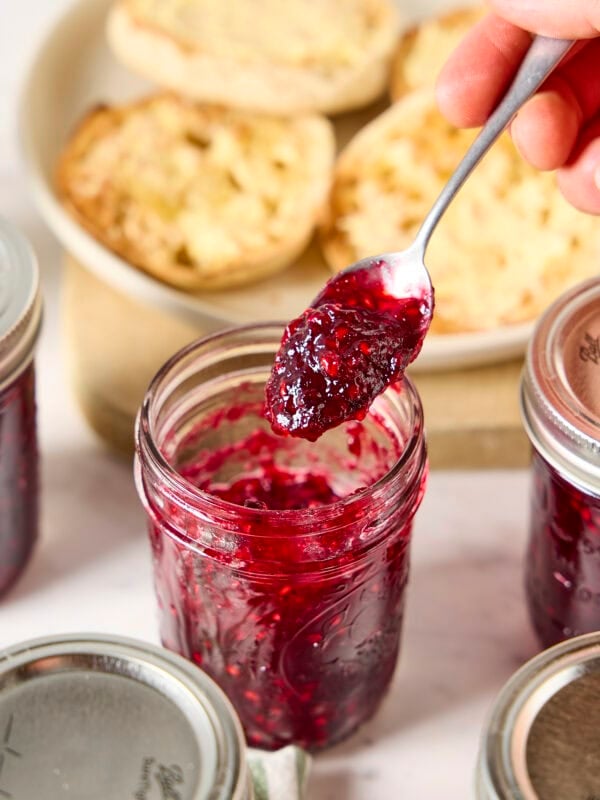 Spoon holding homemade blackberry jam.