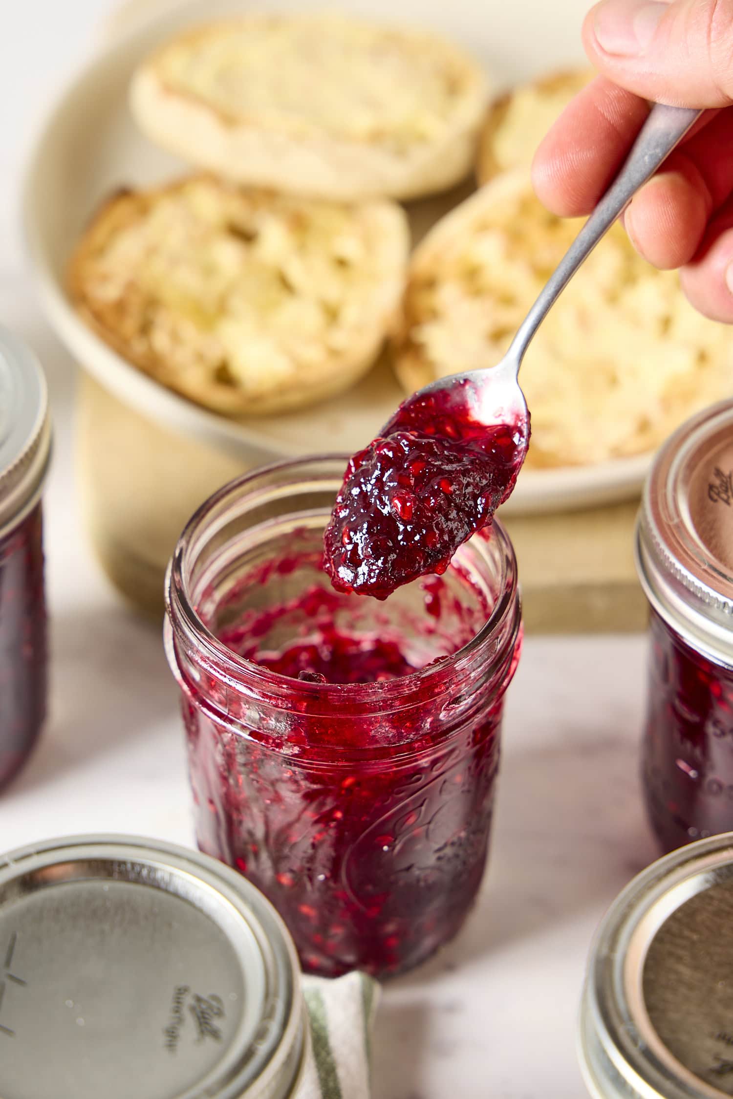 Spoon holding homemade blackberry jam.