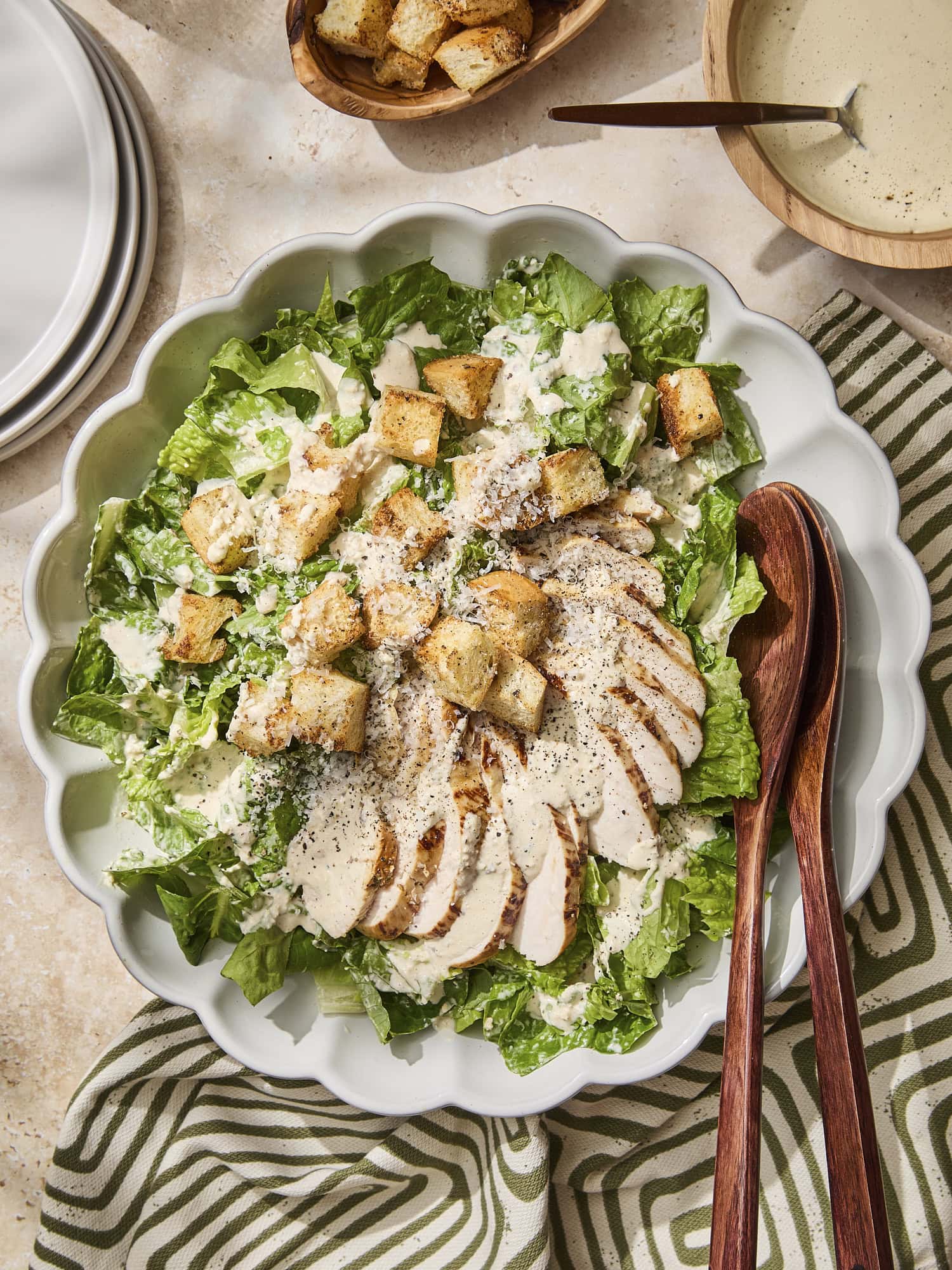Assembled chicken Caesar salad in large bowl.