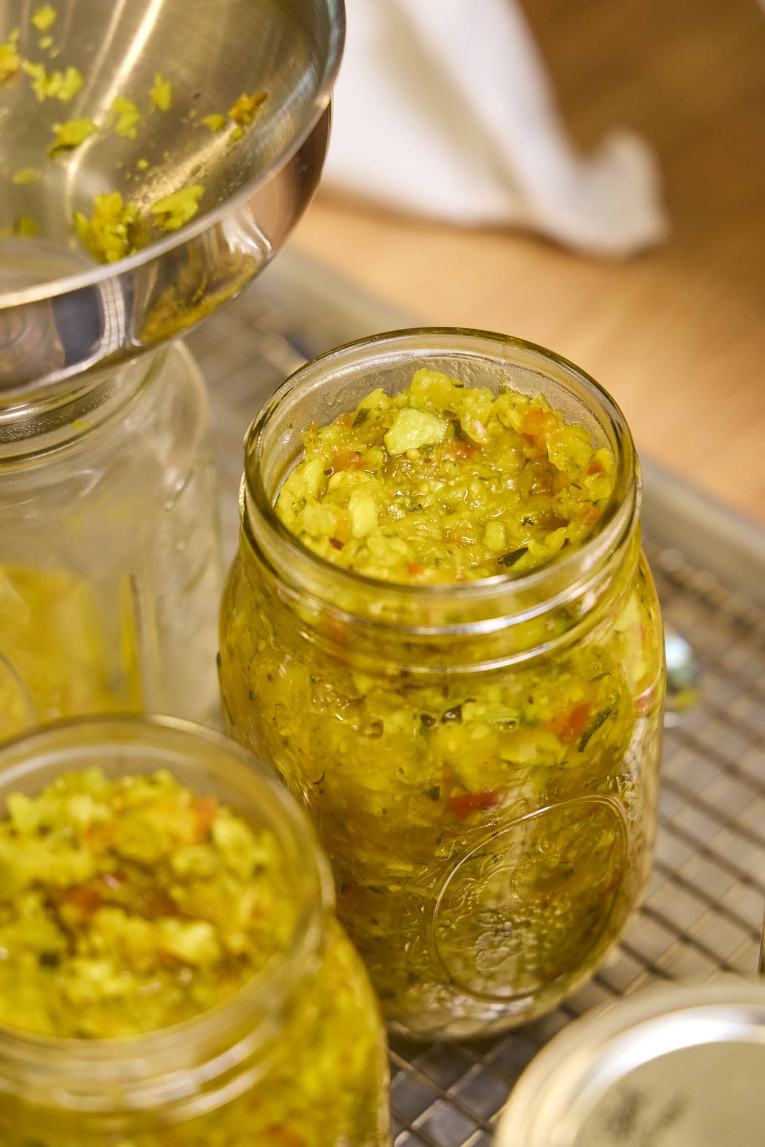 Leaving headspace for relish in canning jar.