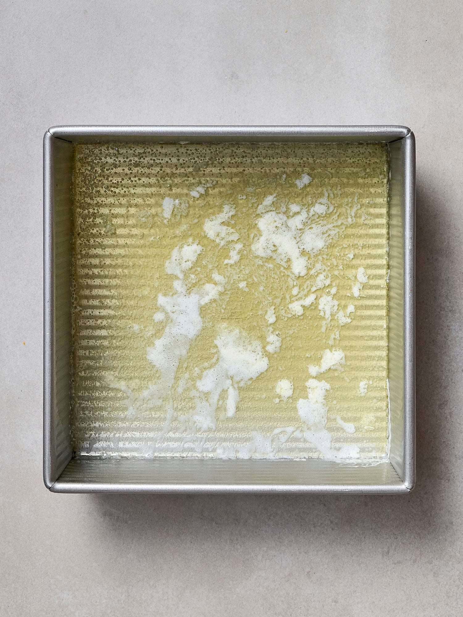 Melted butter in a baking dish.