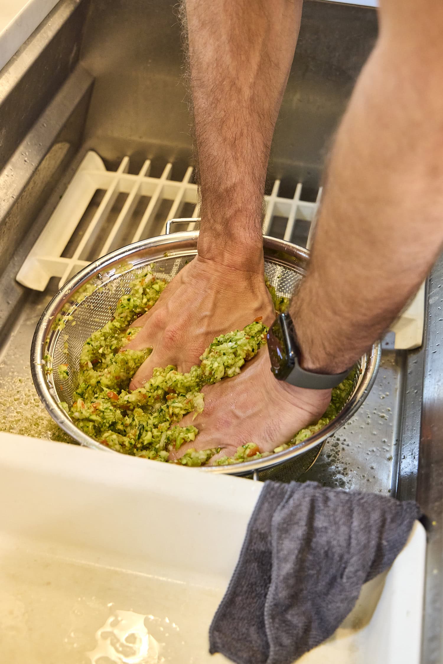 Washing and pressing out excess liquid from chopped zucchini mixture.