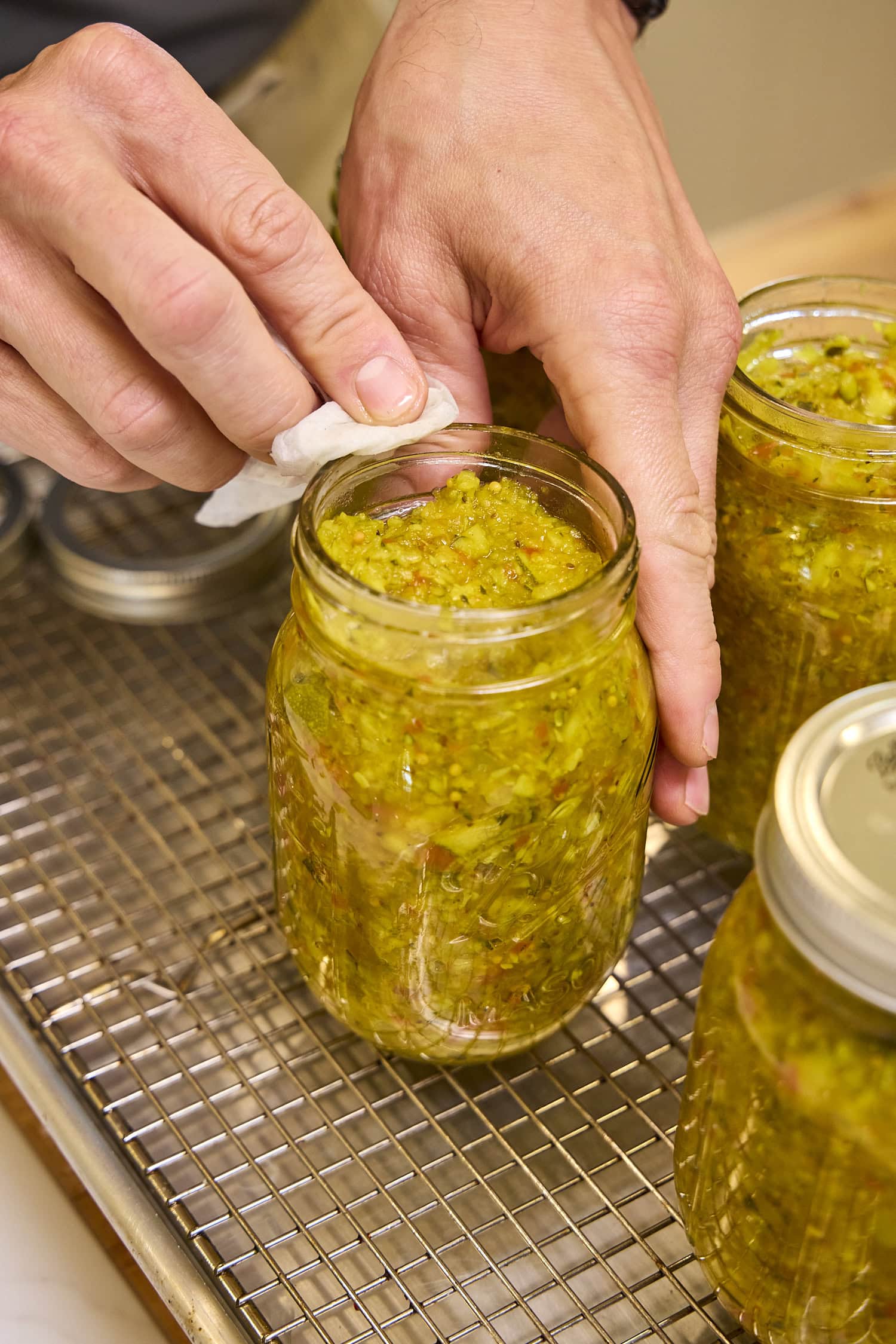 Wiping rim of jar to ensure a good seal.