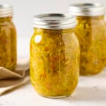 Zucchini relish in a glass canning jar.
