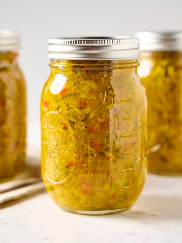 Glass canning jar filled with zucchini relish.