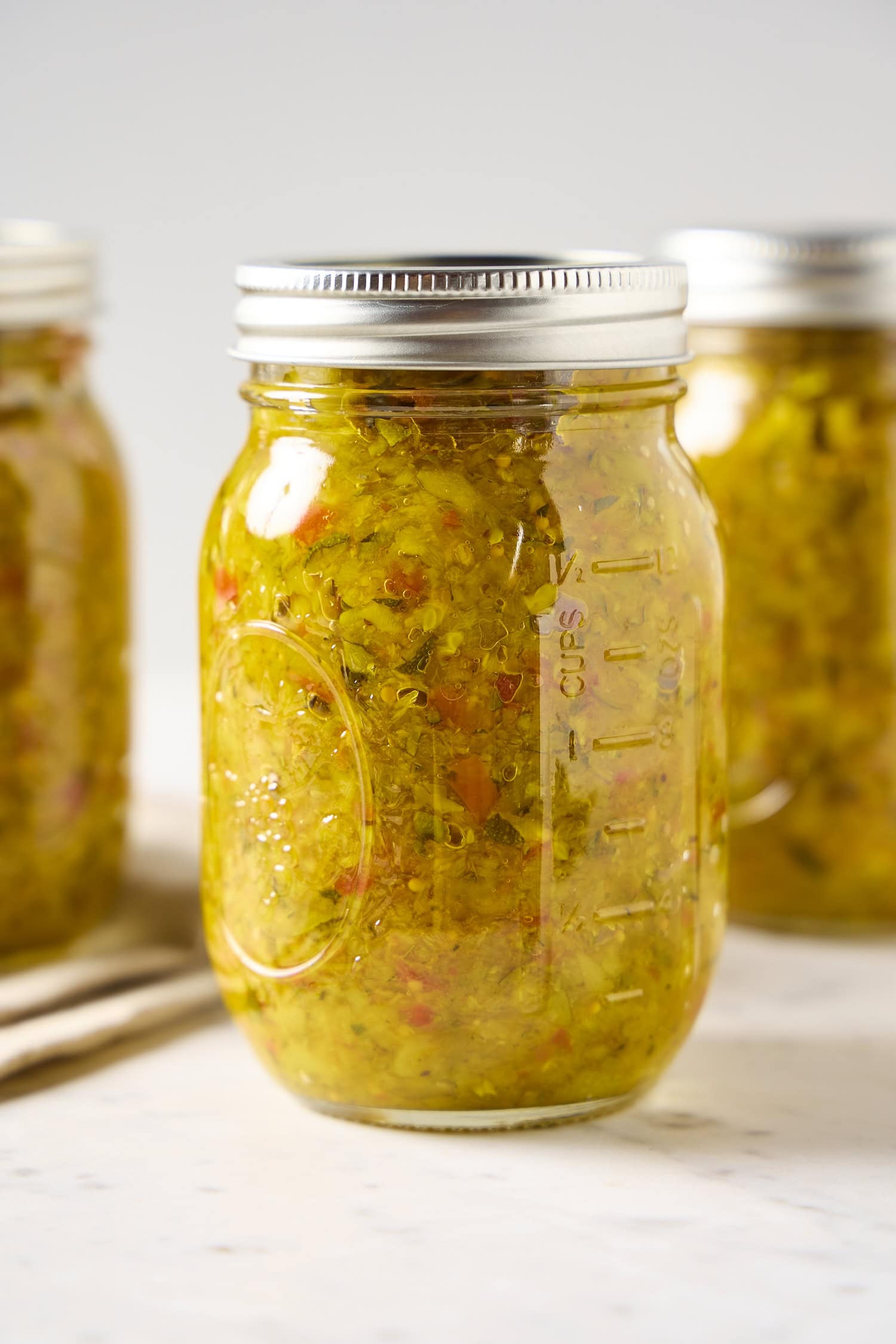 Glass canning jar filled with zucchini relish.