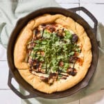 Cast iron skillet with fall pizza recipe baked inside.
