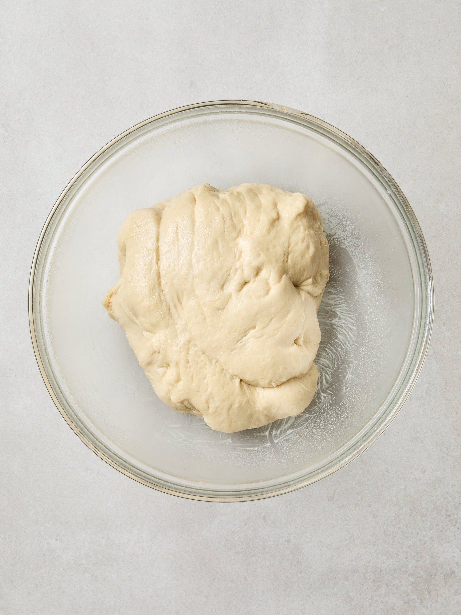 Cinnamon roll dough in an oiled bowl prior to rising.