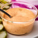 Glass bowl with creamy homemade burger sauce.