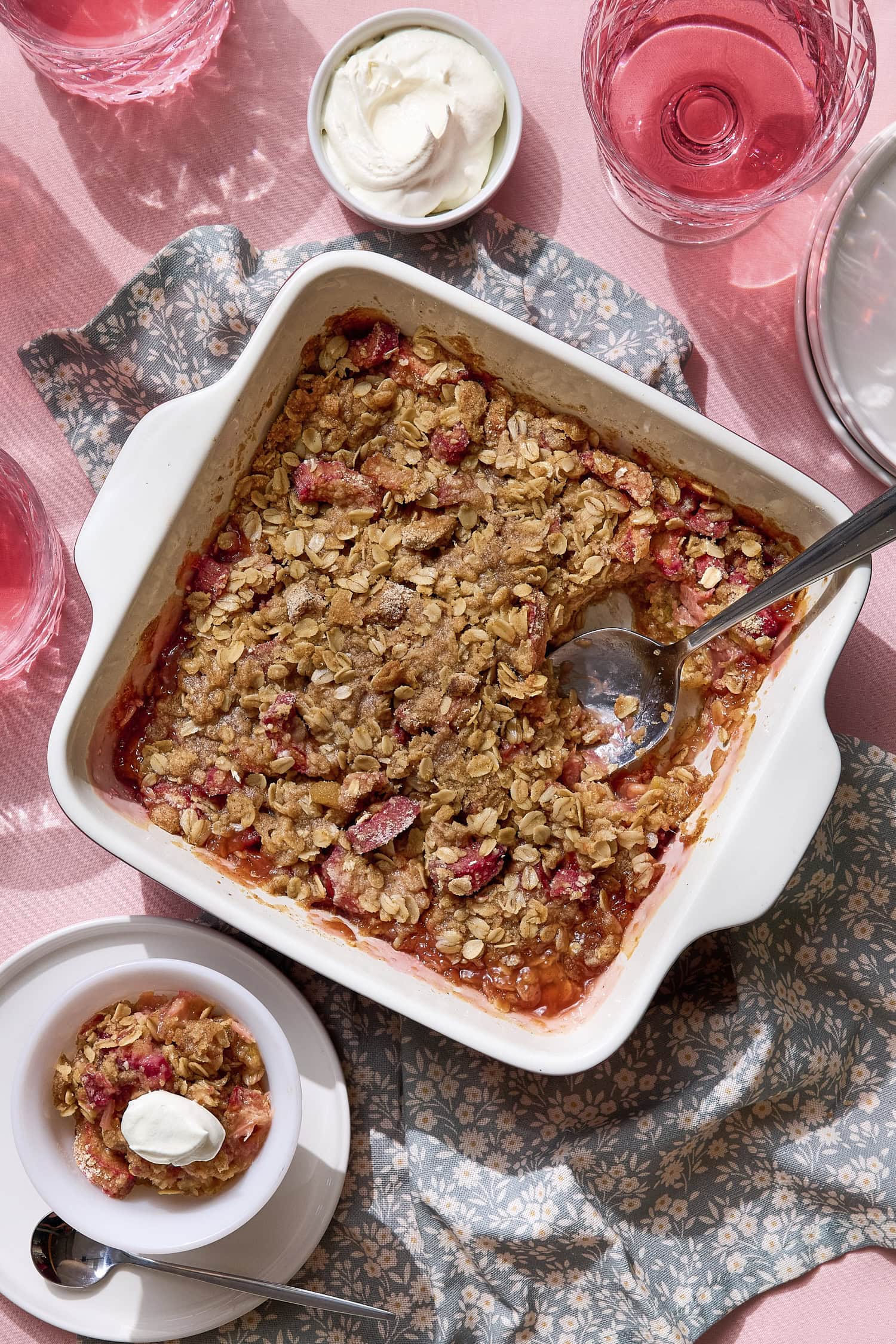 Baked rhubarb crisp with spoon scooping out serving.