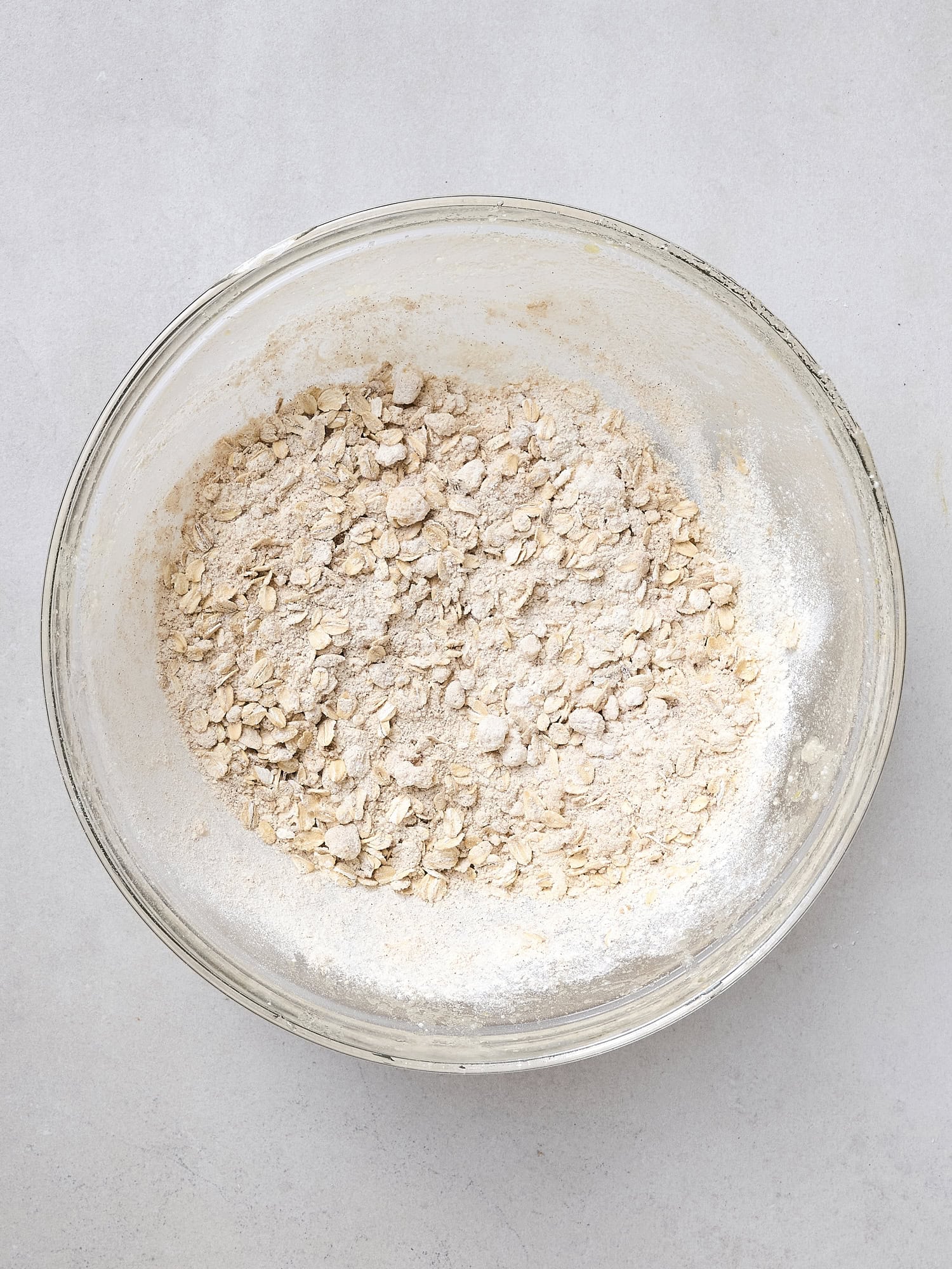 Glass bowl with oat mixture for crisp topping.