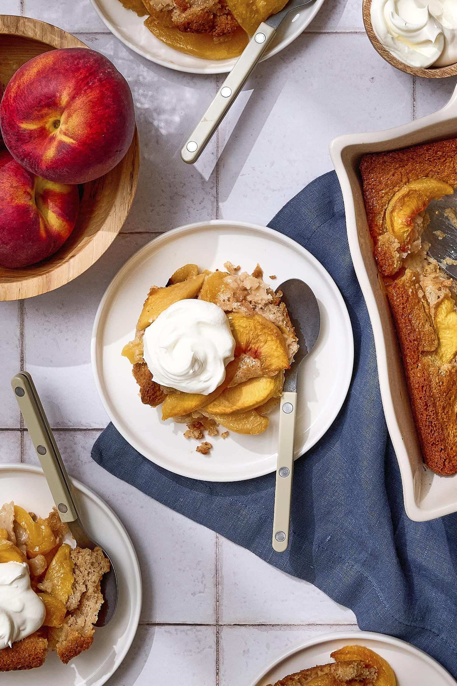 Peach cobbler serving with whipped cream on top.