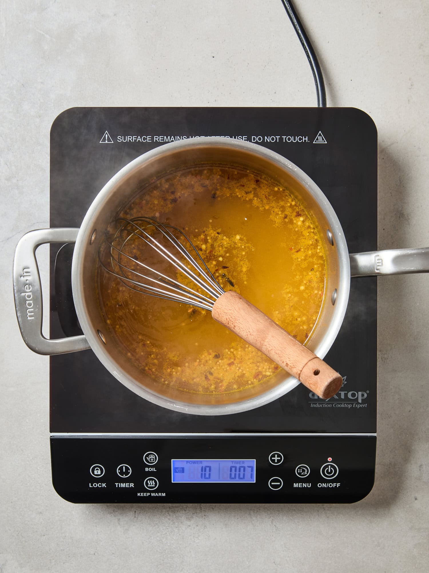 Brine for quick pickles simmering over heat on a cooktop.